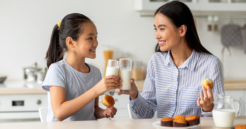 A woman and child drinking milk.