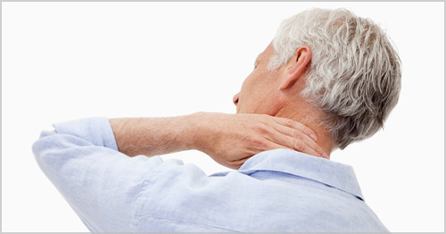A person holding their neck in pain.
